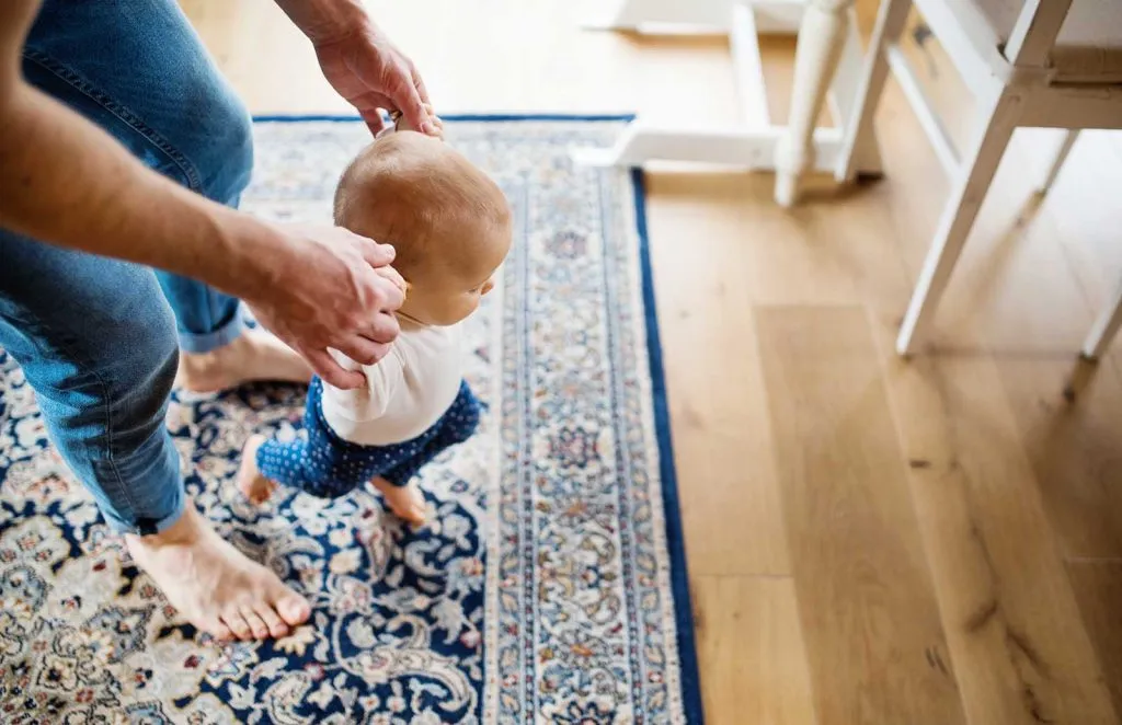 Baby walking on an oriental rug